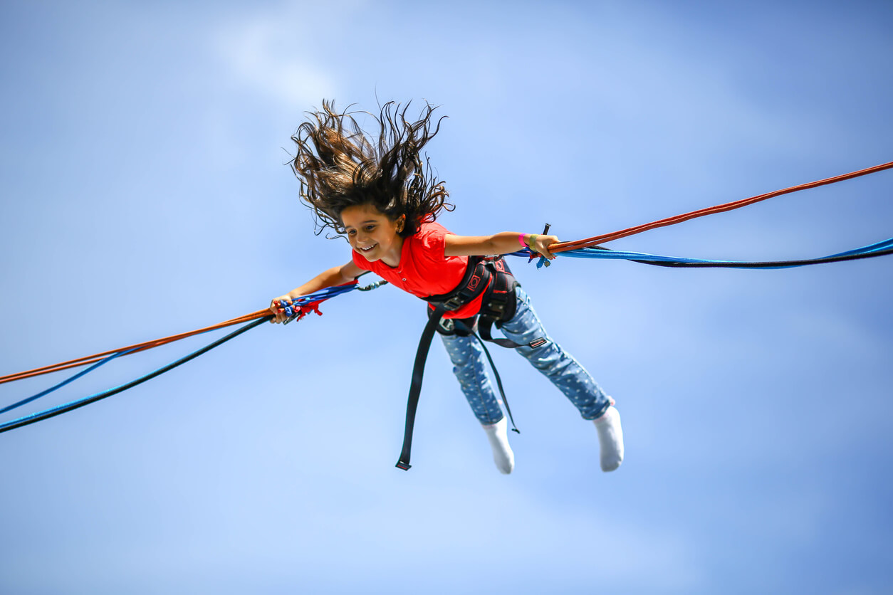 Young girl on a bungee trampoline at Seton Sands