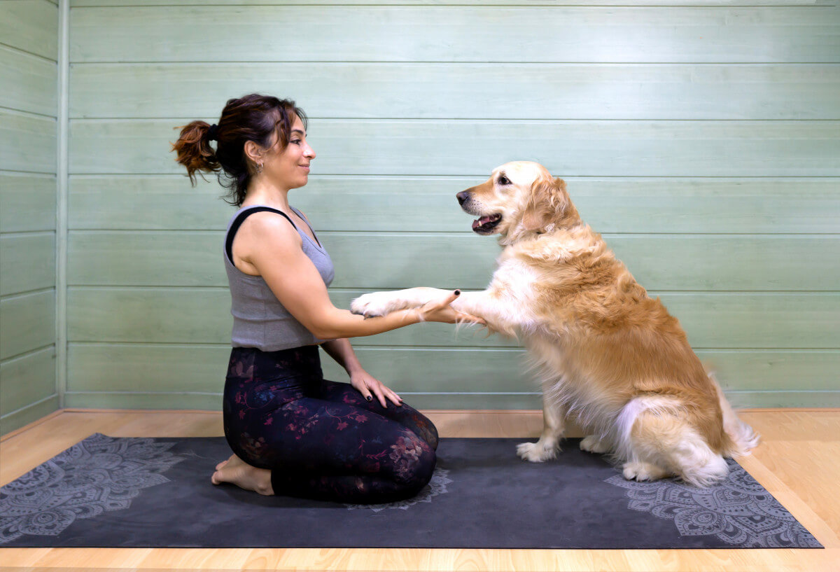 perimenopause stay active woman and her dog doing yoga