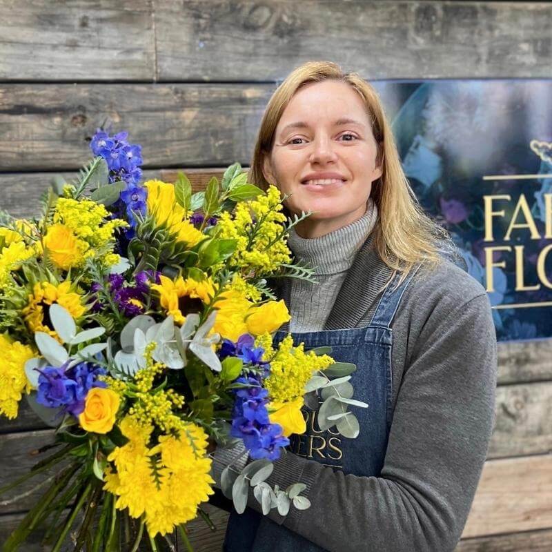 Jayne one of our florists with a beautiful yellow and blue bouquets of flowers