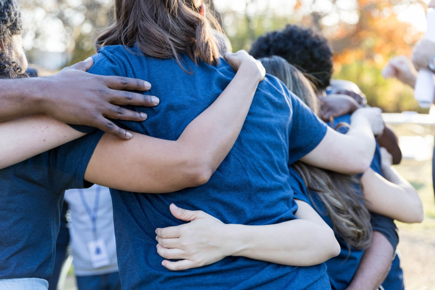People in a circle with their arms around each other - bariatric surgery support groups article