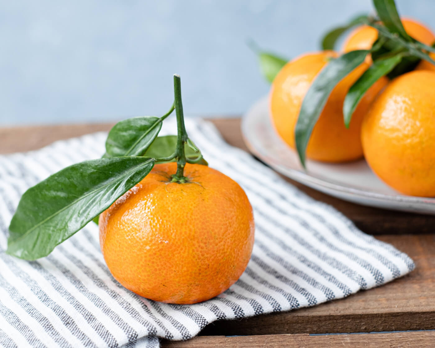 Orange sitting on a blue striped towel | Carbs after Bariatric Surgery article