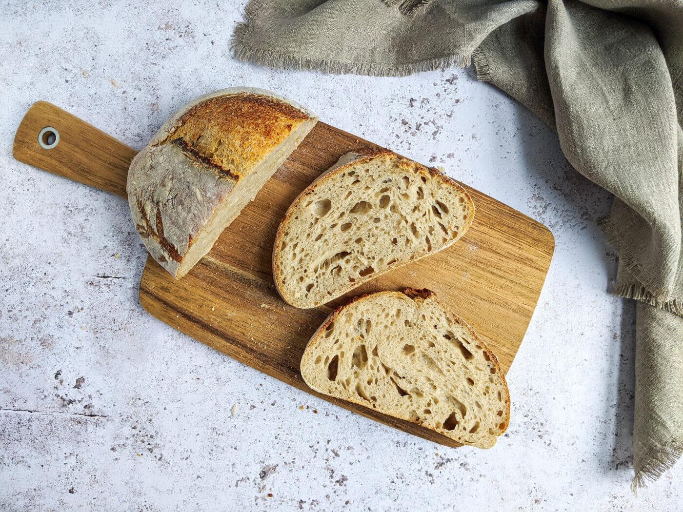 Two slices of bread and half a loaf on a cutting board | Carbs after Bariatric Surgery article