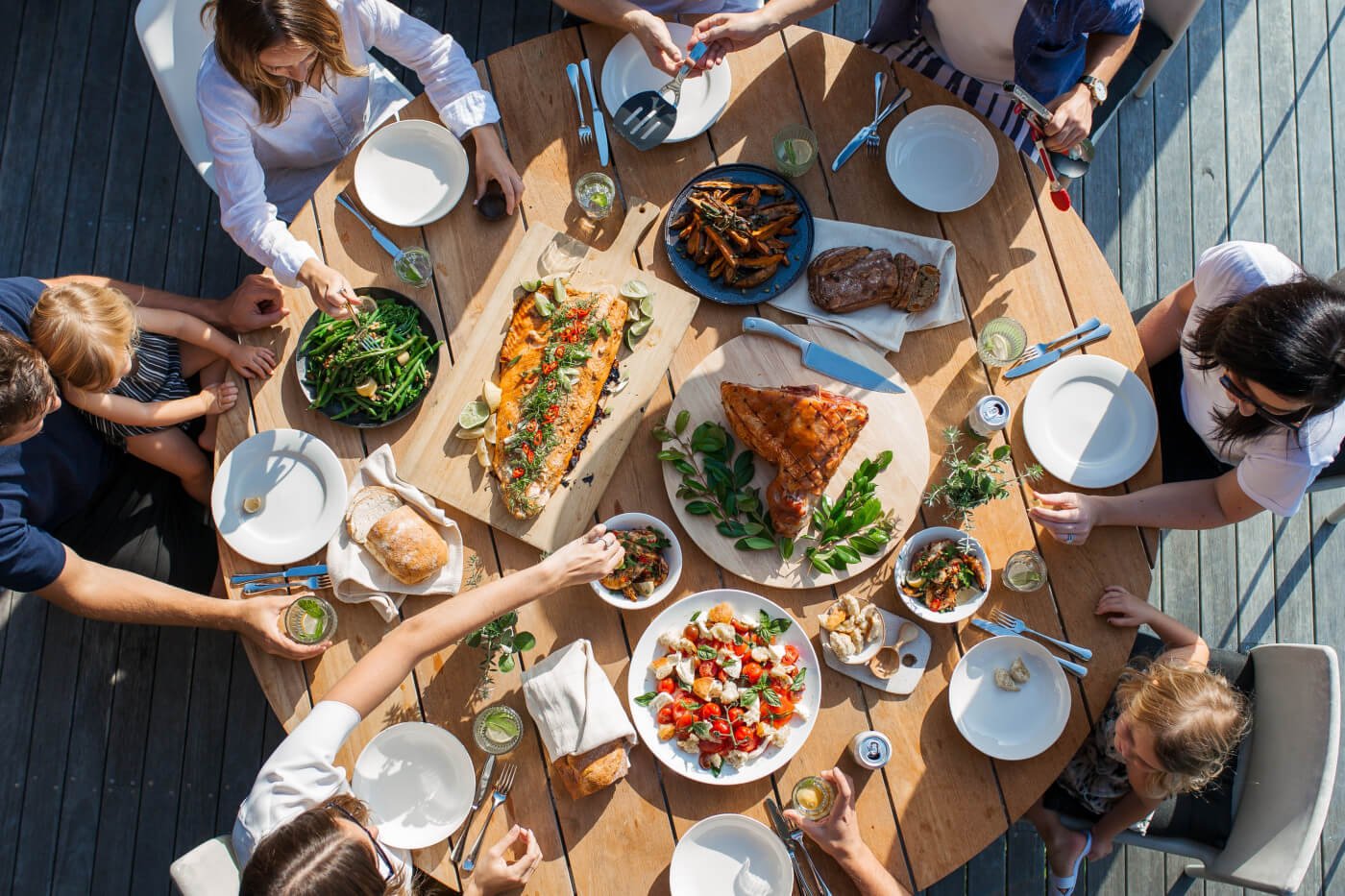 Overhead shot of people gathered around a round dinner table | Eating Out After Bariatric Surgery Article
