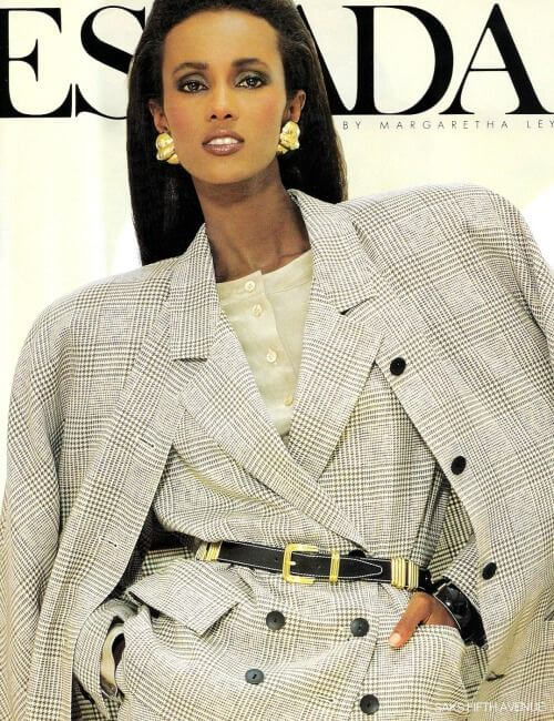 80s Power Suit - A model wears a belted pleated power suit, Escada magazine, 1988