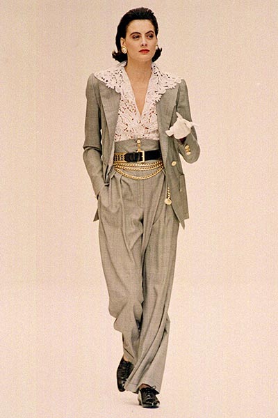 80s fashion - Ines de la Fressange is wearing a Chanel power suit, a lace shirt and a belt with chains, 1980s