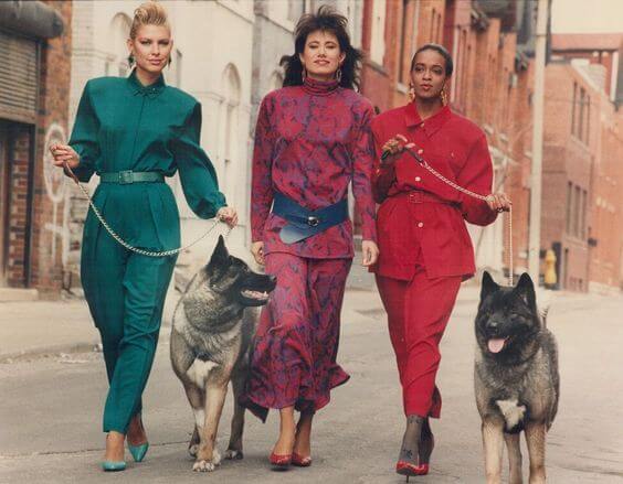 80s power suits - Three models in colorful power suits while going for a casual walk down the street
