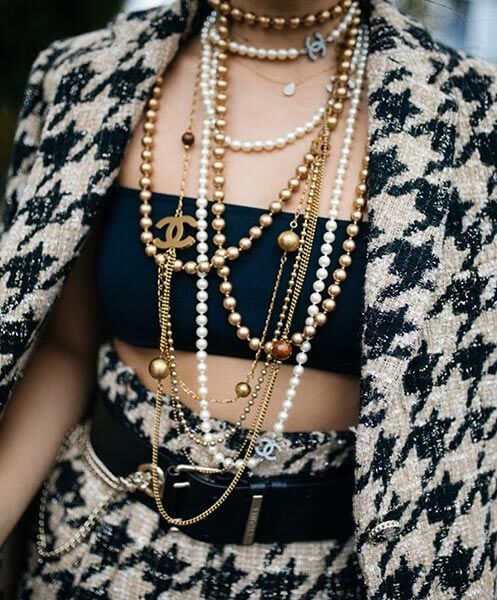 Multi-strand pearl necklaces accented with gold beads by Chanel.