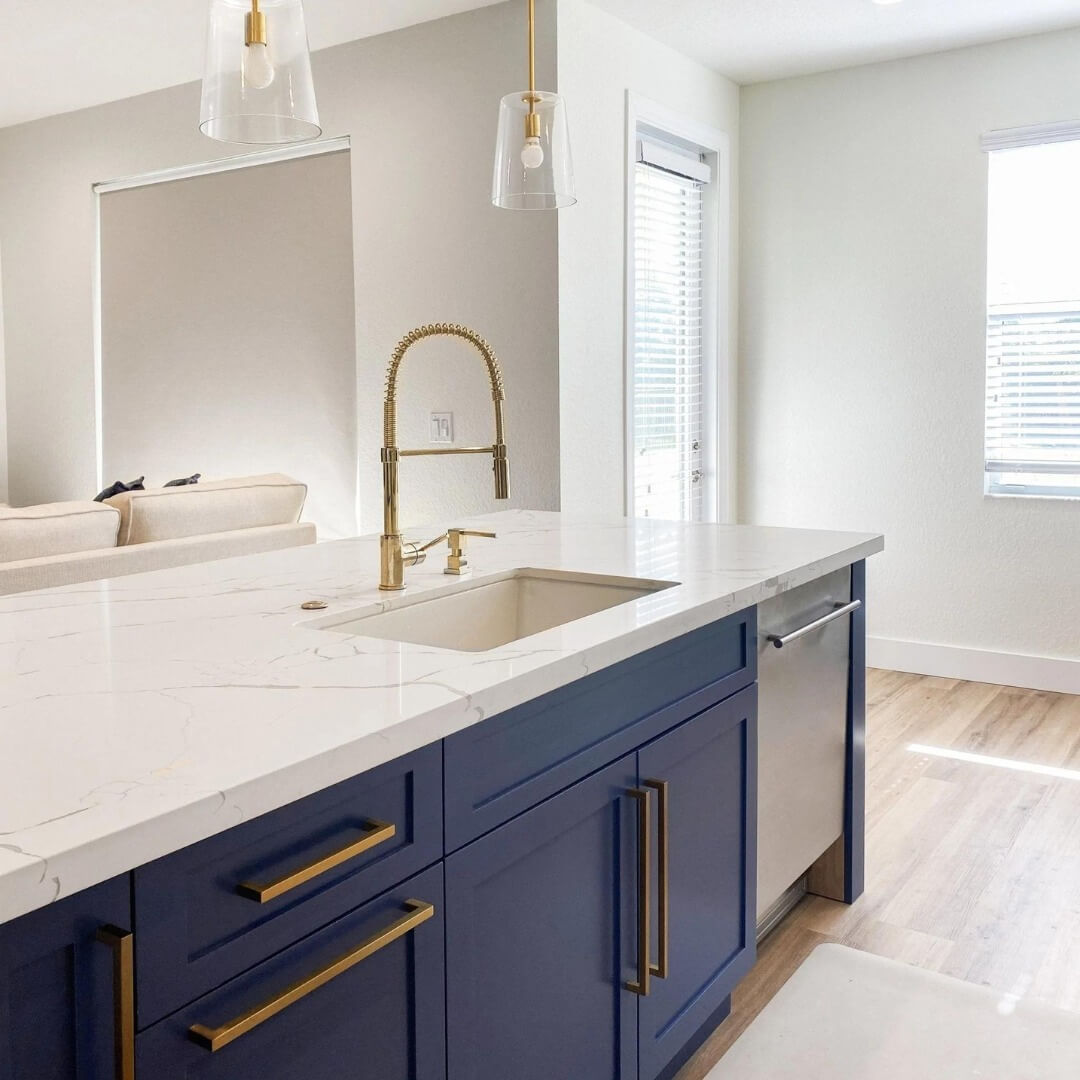 Blue Kitchen Island with White Countertops and gold hardware Lifestyle with sink and dishwasher