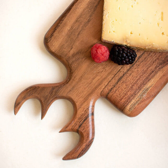 Cutting board with wooden deer antler carving