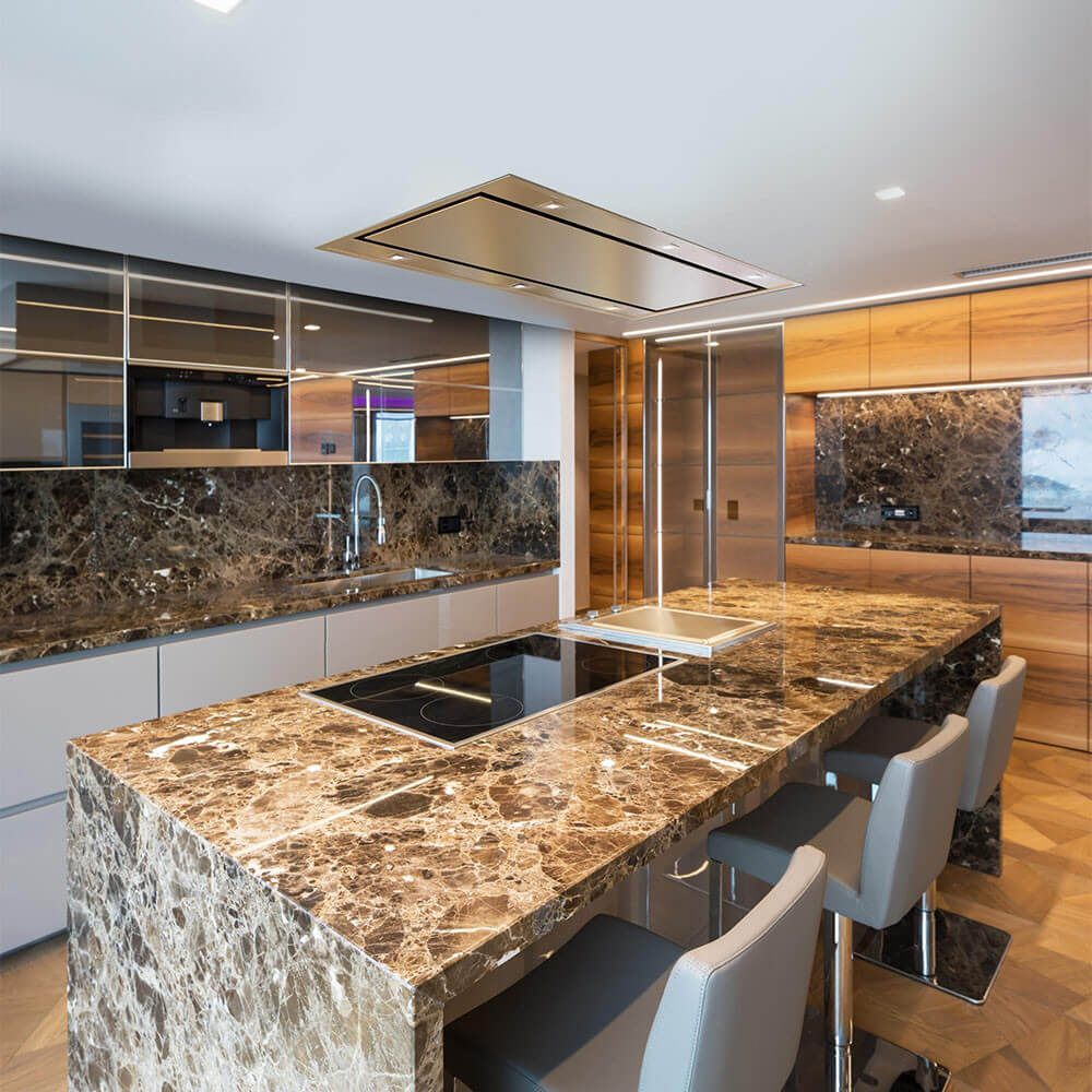 Forté Vertice Recessed Ceiling Mount Hood in a modern kitchen with marble kitchen island