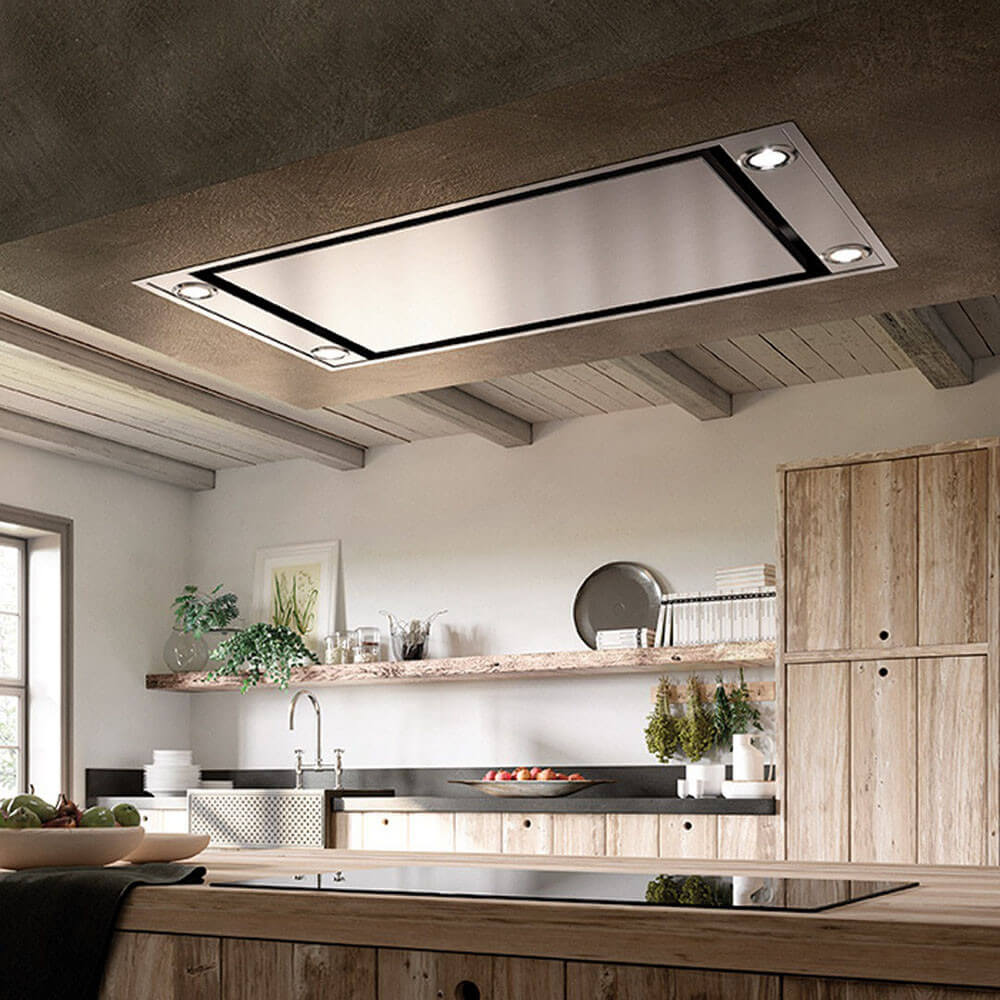 A Faber ceiling mount range hood in a rustic kitchen above induction cooktop