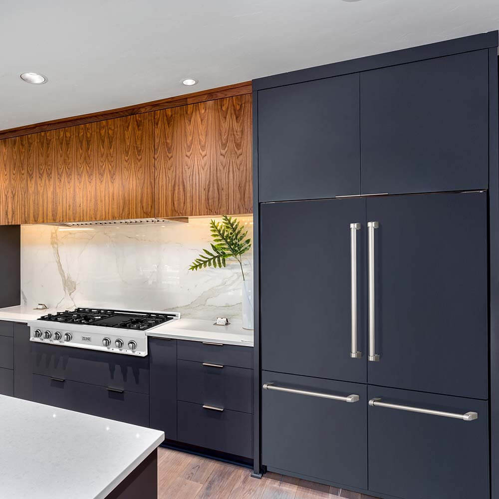 60-inch built-in refrigerator with custom navy blue panels that matches cabinets.