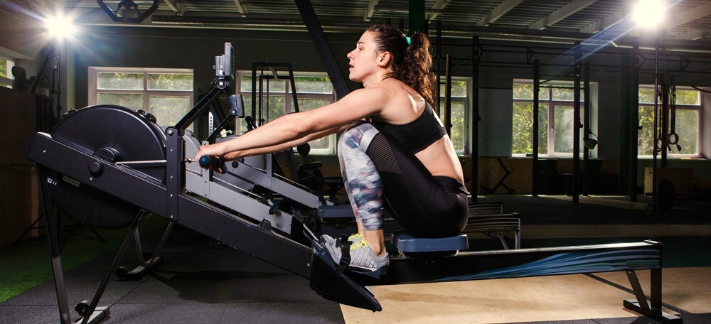A woman on a rowing machine demonstrates how long should you work out on a rowing machine for
