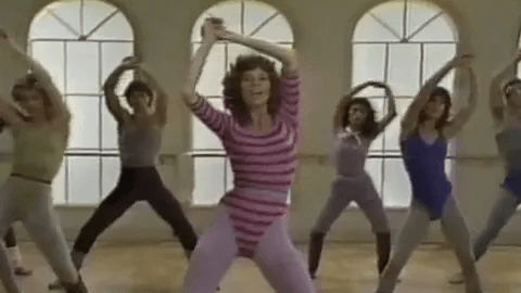 Jane Fonda poses in a Spandex ensemble, demonstrating her workout