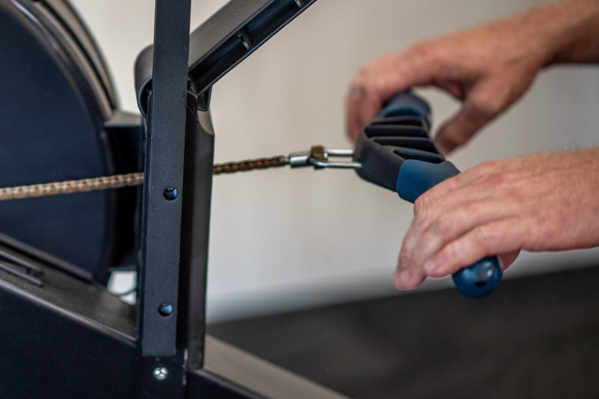 Closeup of the indoor rowing catch position.  Light hand grip at the Catch - fingers are loose, like they are playing the piano