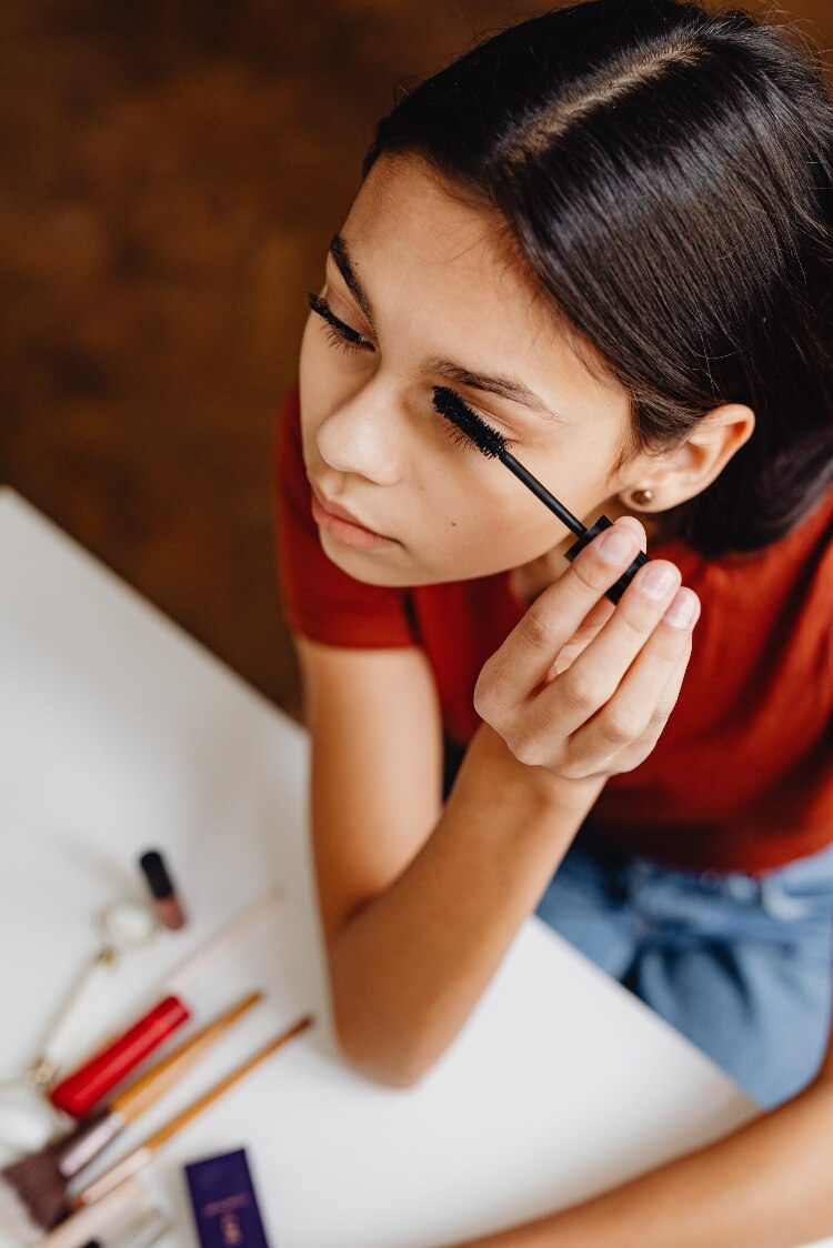 Picture of girl applying the best mascara for short lashes