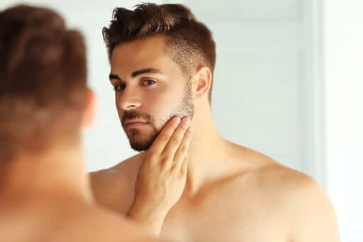 Grooming beard in mirror