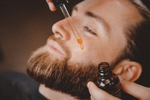Man using beard oil | Does beard oil help growth?