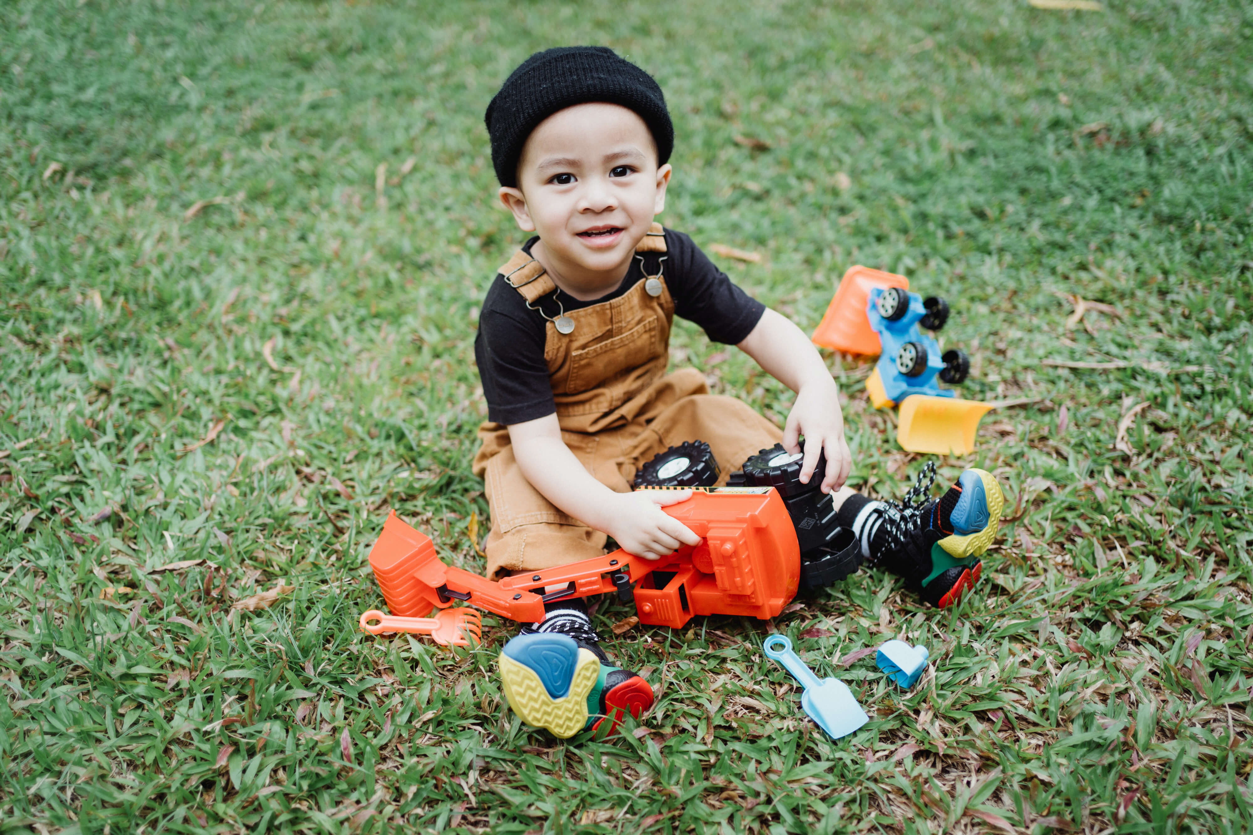 A boy playing with his STEM toys on the grass