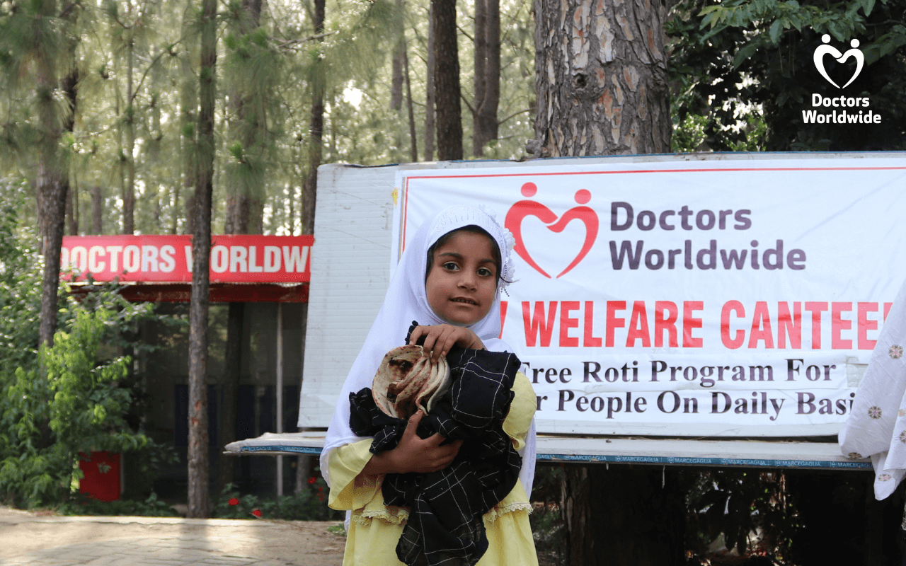 A girl holding food she got from the Doctors Worldwide welfare canteen