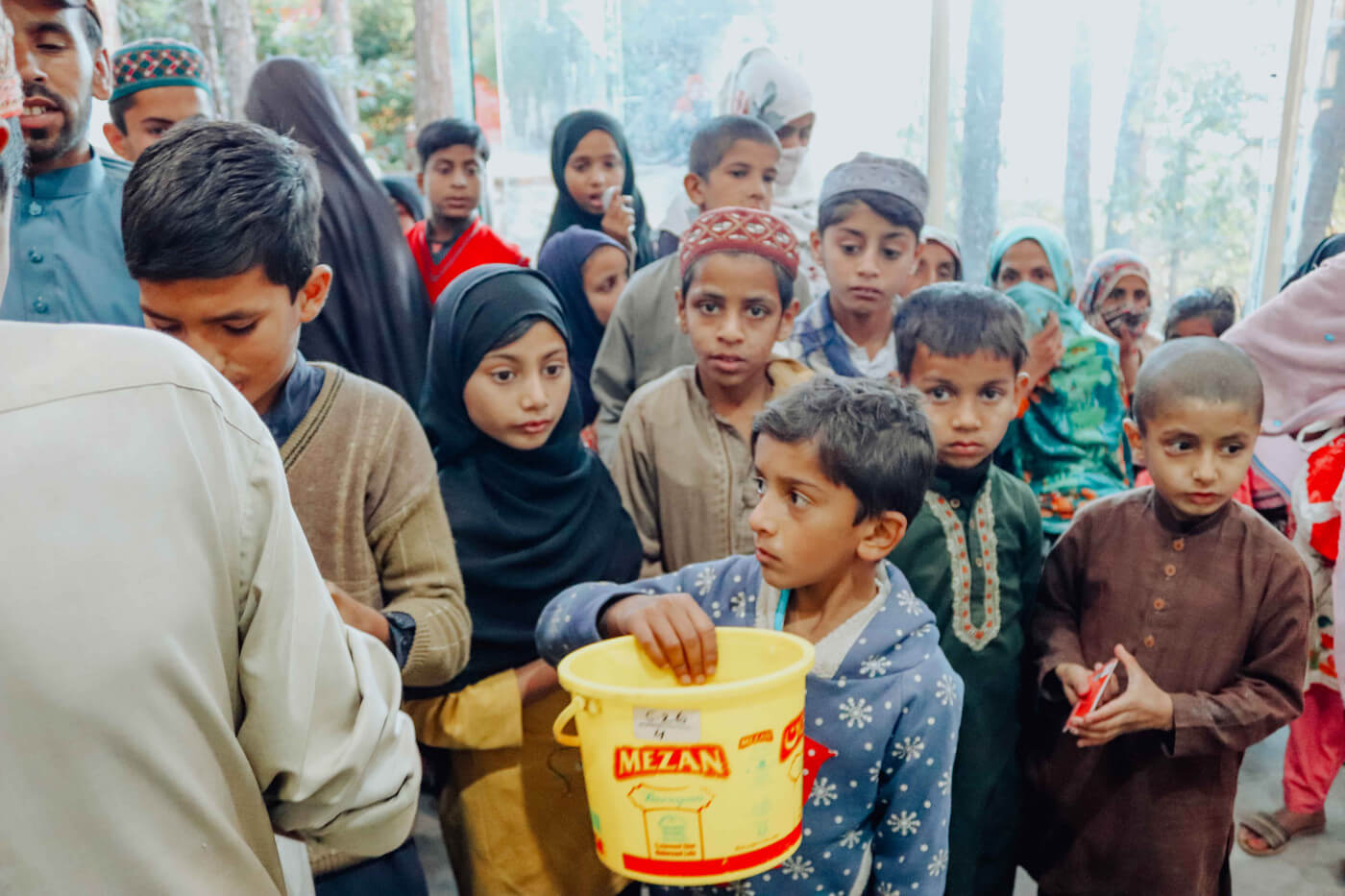 children receive food packs and hot meals at doctors worldwide hospital canteen pakistan