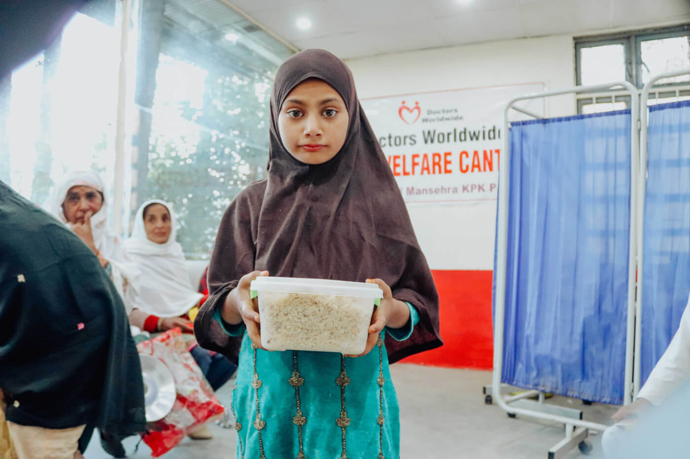 young girl holding food at doctors worldwide hospital canteen in pakistan