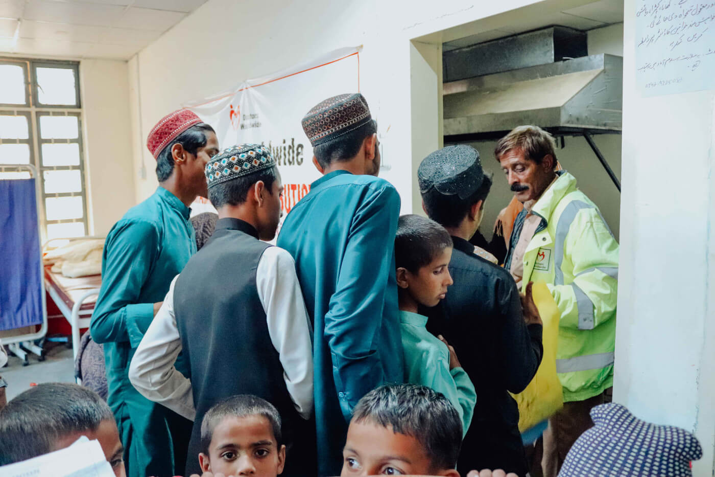 families queue to receive food packs and hot meals at doctors worldwide pakistan hospital canteen