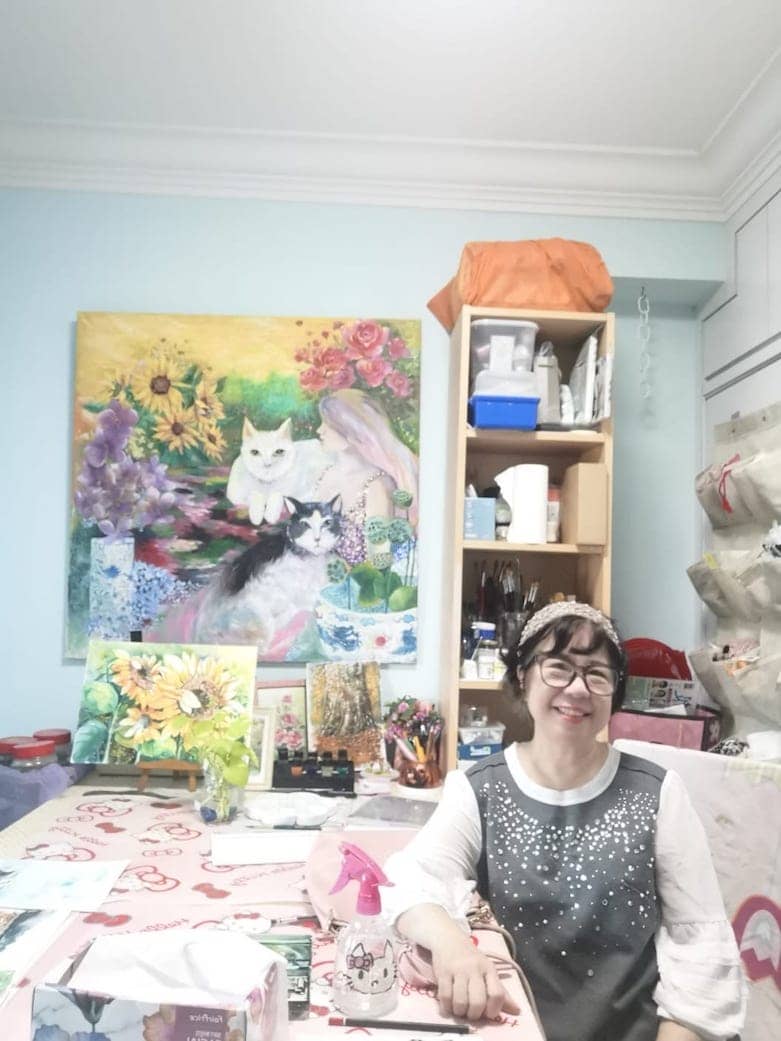 Diana Lim with her paintings of cats.