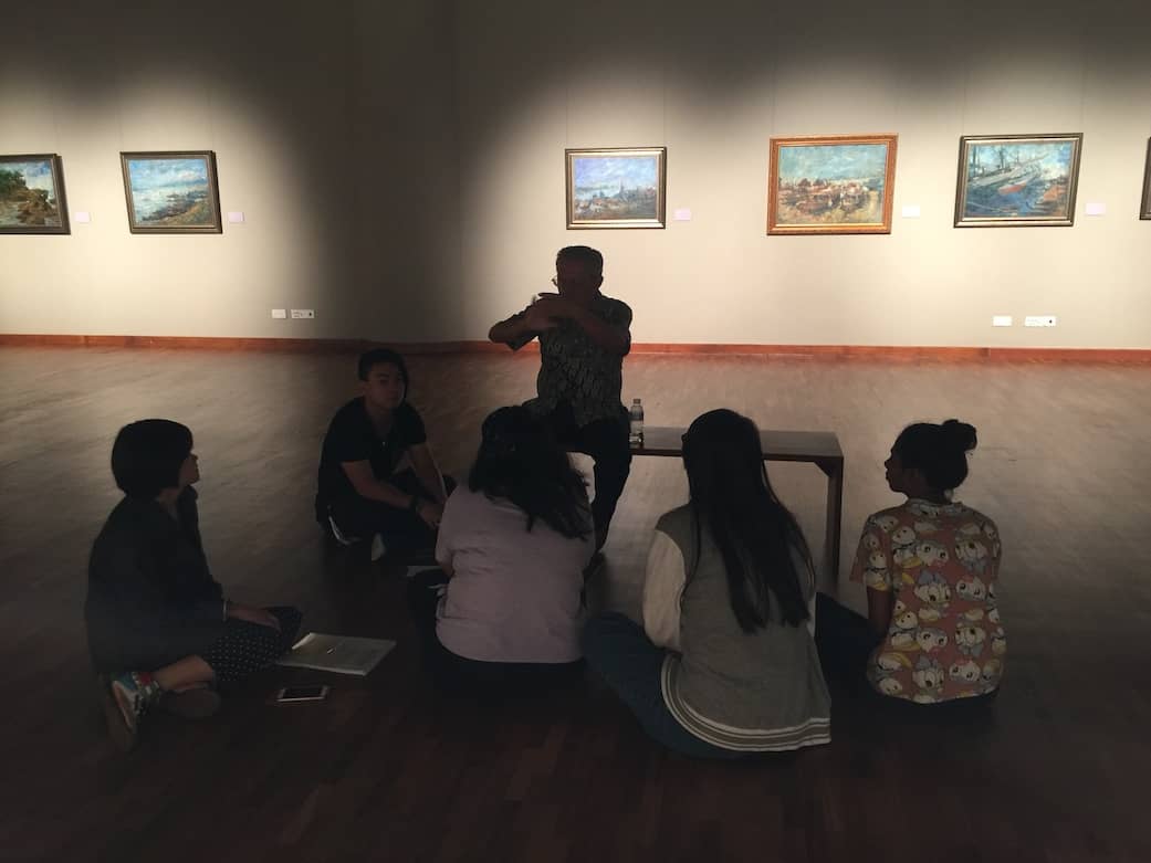 Famous artists Singaporean Low Hai Hong sharing his art with students at his art exhibition.