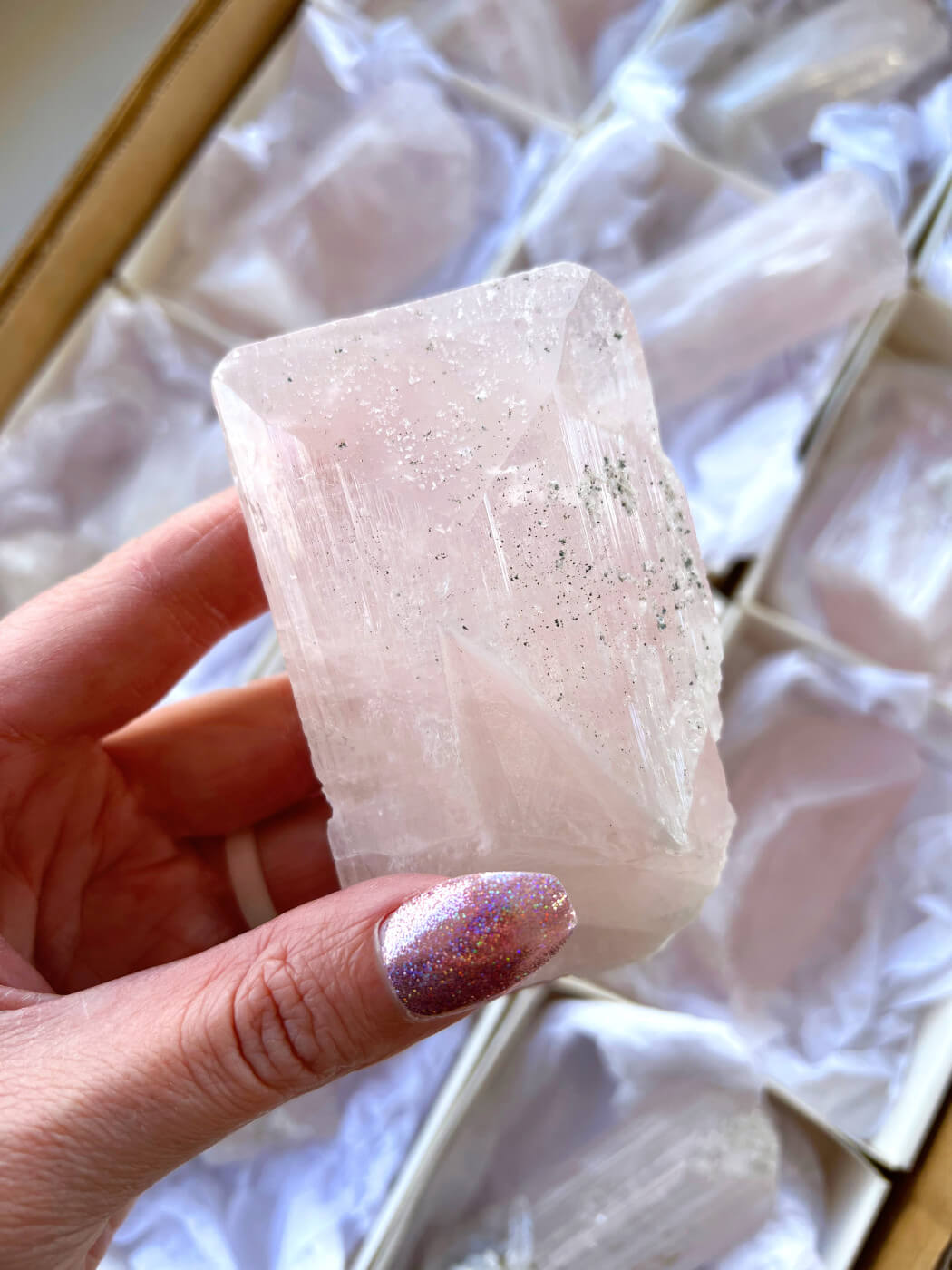 Crystal vs. Mineral: pink danburite from Mexico coated in fine sparkly quartz crystal druse.