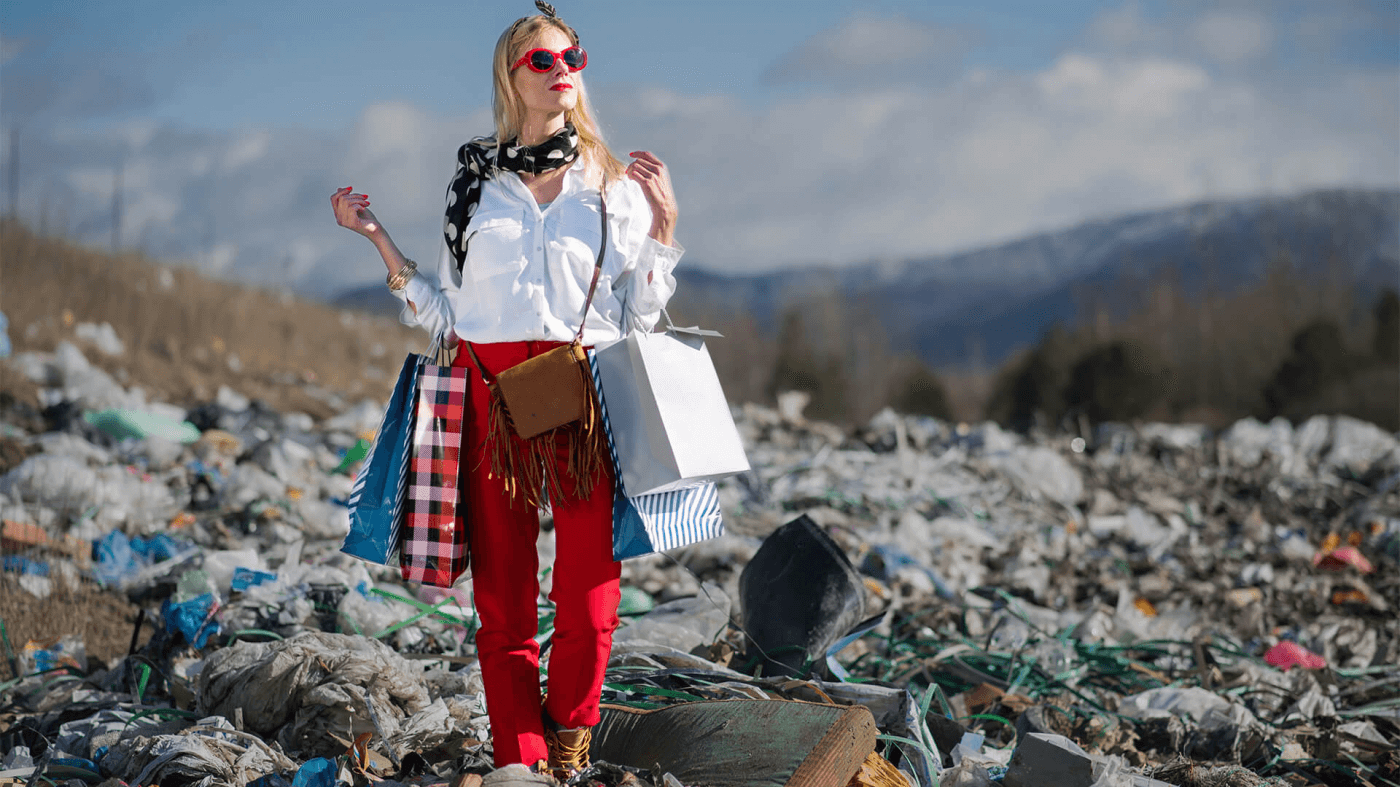 girl with shopping bags walking over a landfill