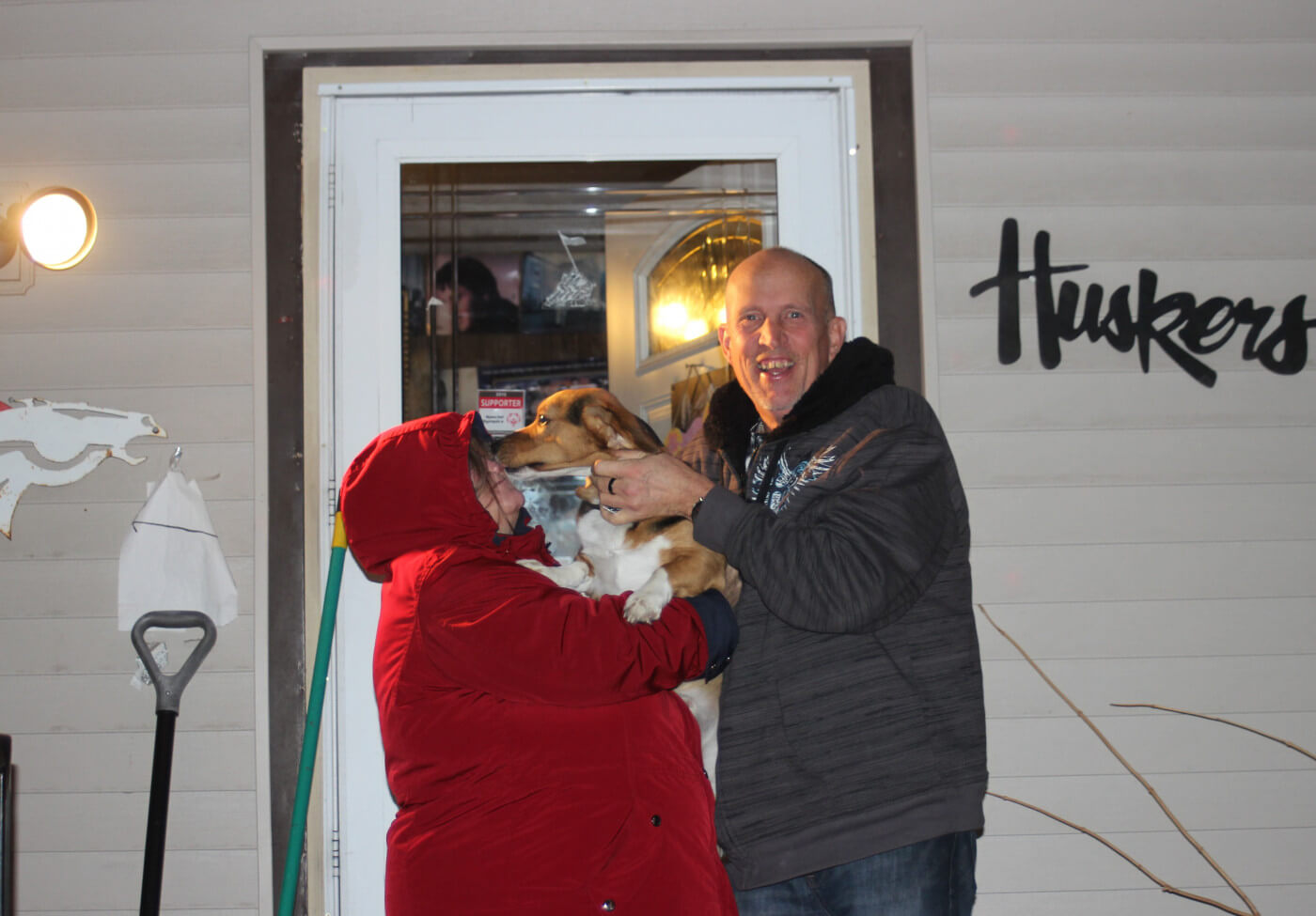Cindy and Henry holding Skipper in Front of House posing for picture for rural mobility pilot.