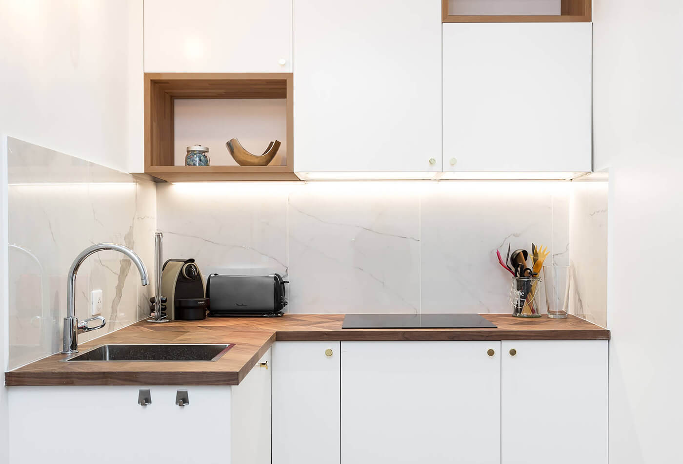 White Stone Backsplashes And Wooden Butcher Blocks Are a Pair Made In Heaven!
