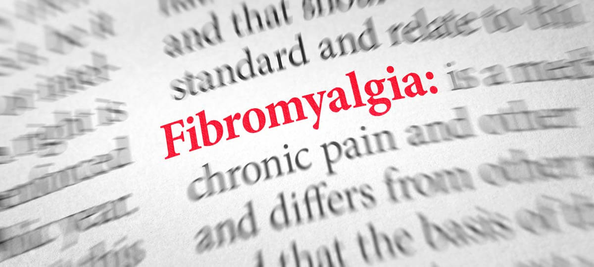 Close up of blurred photo of dictionary definition of fibromyalgia