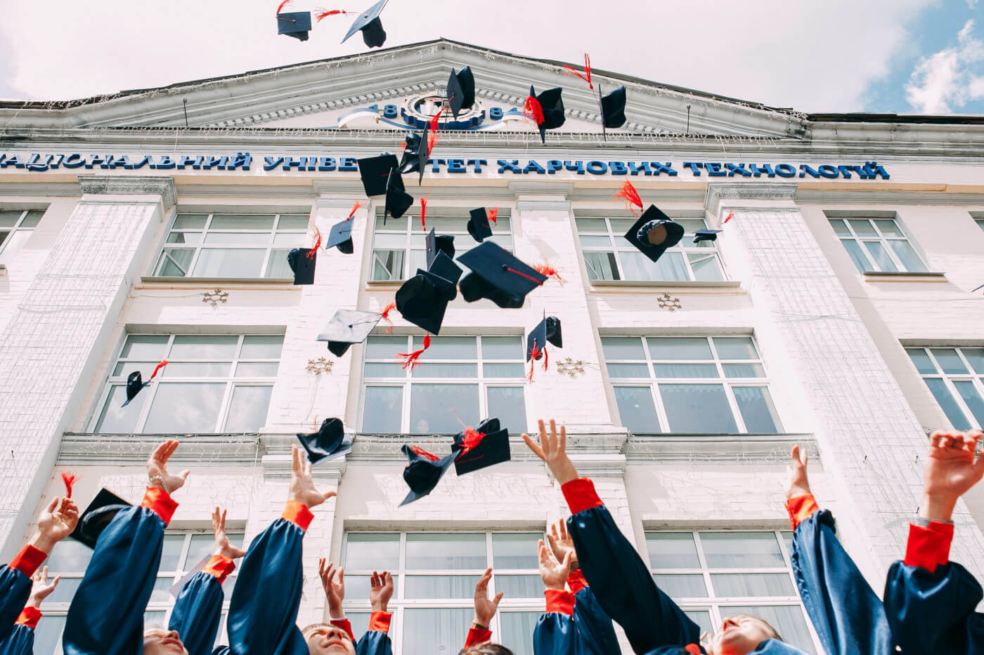 Students throwing graduation caps in the air in celebration Credit: Unsplash