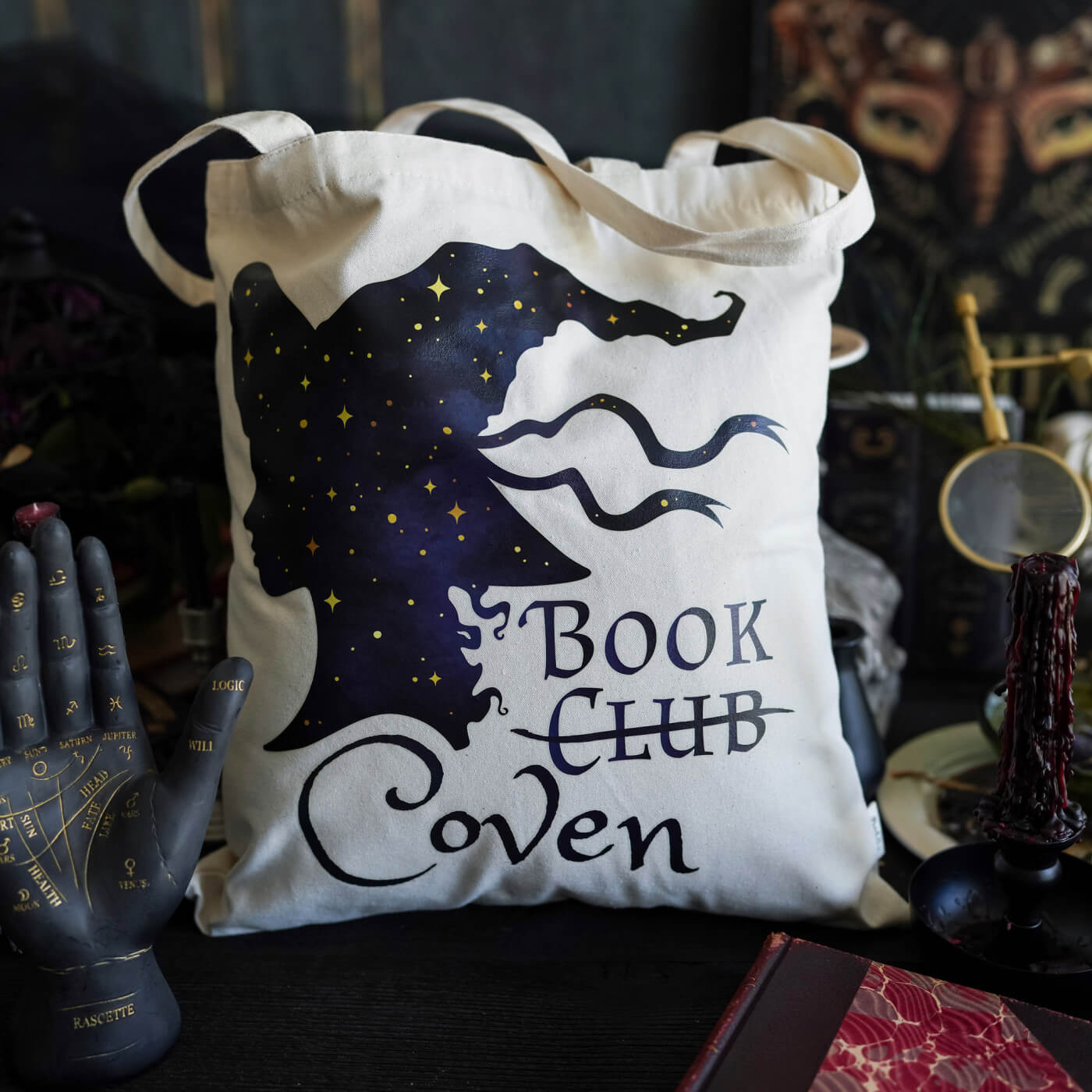 Book Coven Tote sold by LitJoy with a witchy silhouette and reads "Book Club Coven" with "club" crossed out