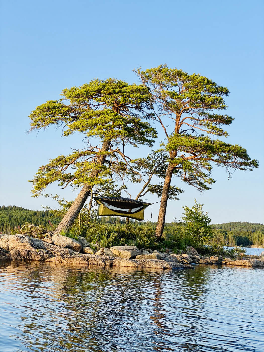 A Haven tent hanging between two trees on an island | places to hang a hammock