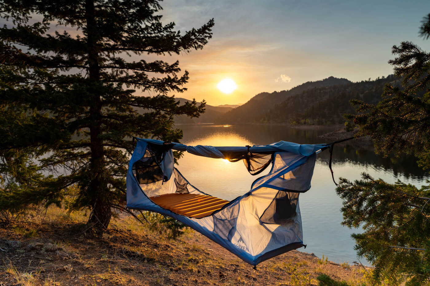 camping for beginners. A Haven Tent is setup next to a lake,