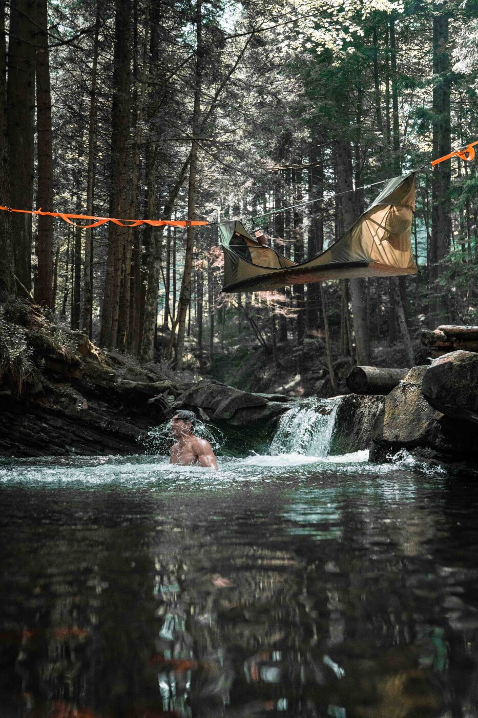 jumping out of a Haven Tent over a stream into a pool