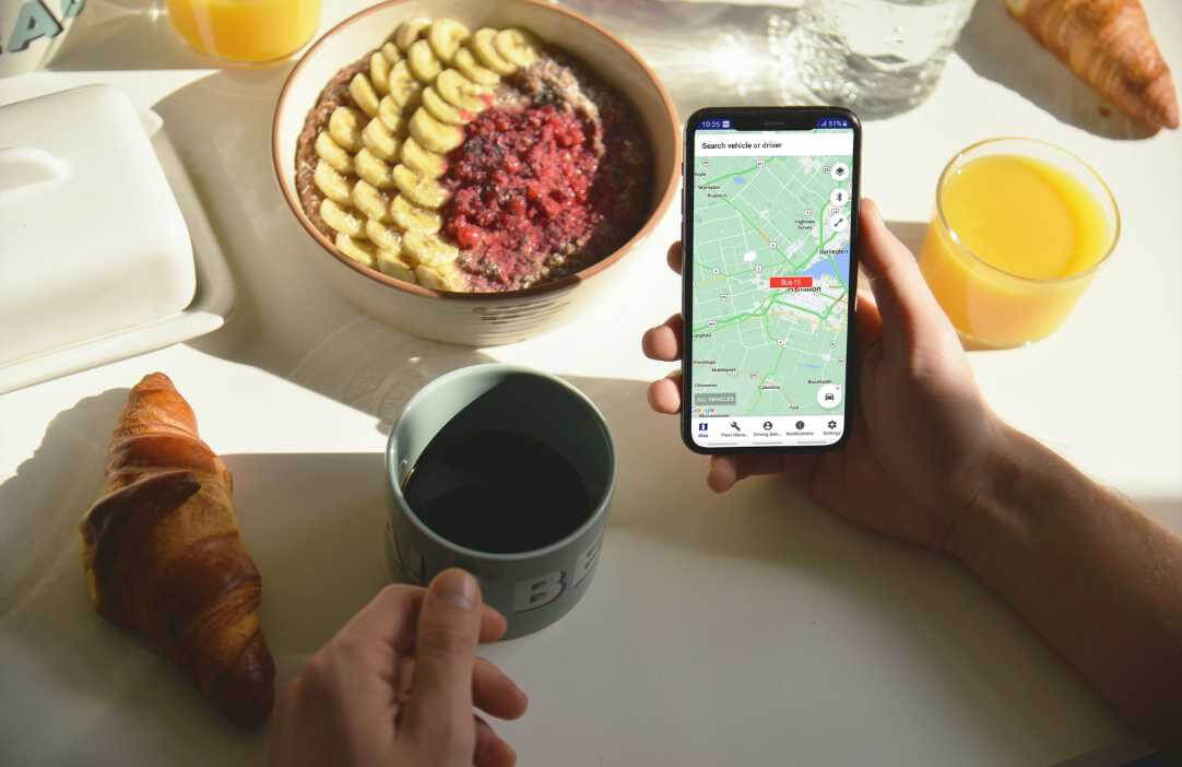 Trackem App on Phone eating breakfast