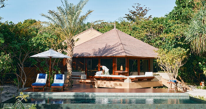Beach hut and sun loungers by the pool at Amanpulo