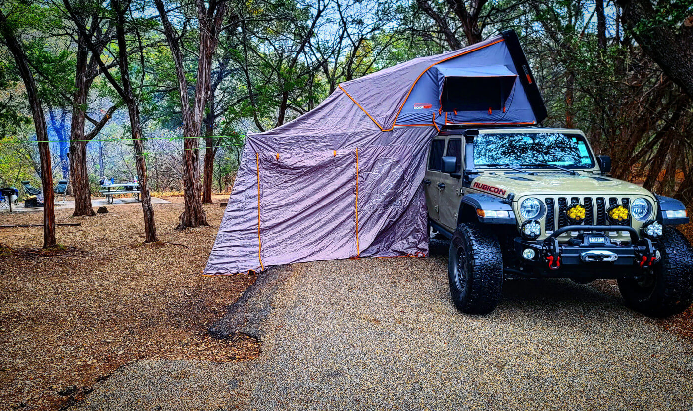 Kenny's Gladiator with his rooftop tent setup for camping