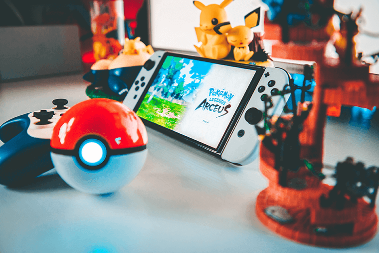Nintendo Switch surrounded with Pokemon miniatures